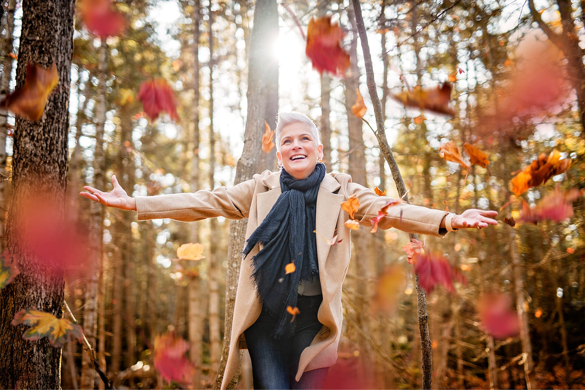 Woman enjoying herself while leaves fall